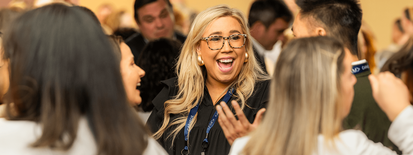 Group of women at an AMA event laughing and socializing between sessions.
